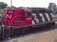 CN 4589 is seen at the CN Niagara Falls Yard in August of 1982. The old Cynamid chemical plant, which was closed and demolished in the 1990's, is seen in the distance just above the locomotive. Not much is left here today with the yard gone.