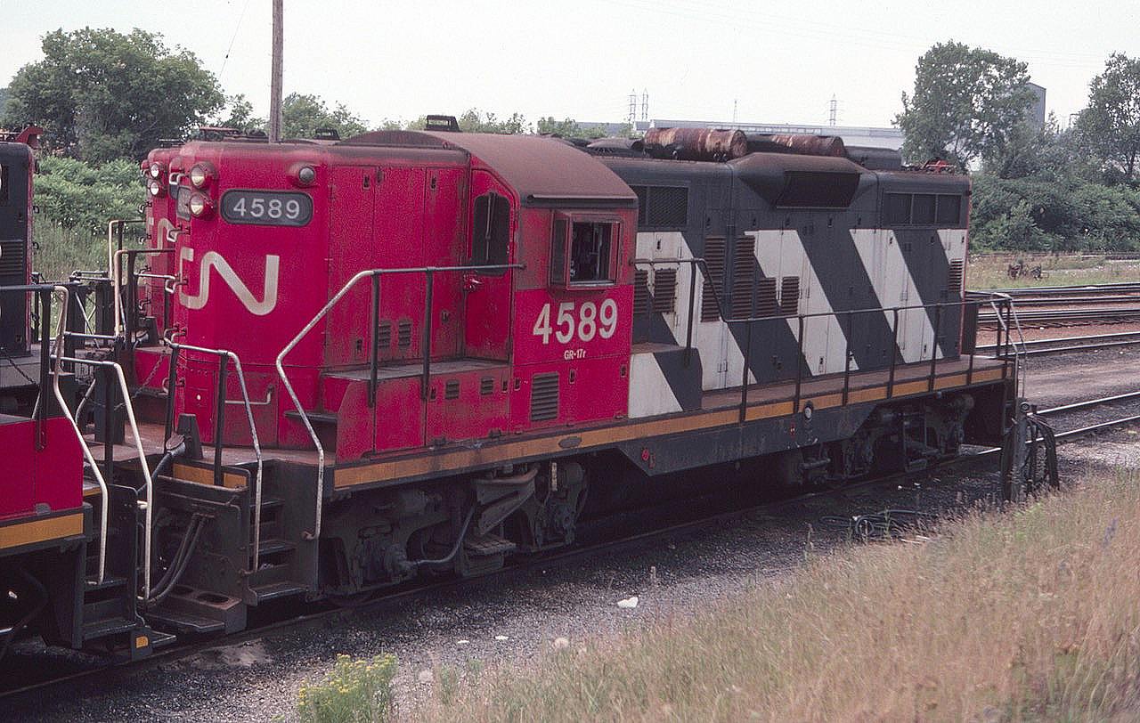 CN 4589 is seen at the CN Niagara Falls Yard in August of 1982. The old Cynamid chemical plant, which was closed and demolished in the 1990's, is seen in the distance just above the locomotive. Not much is left here today with the yard gone.