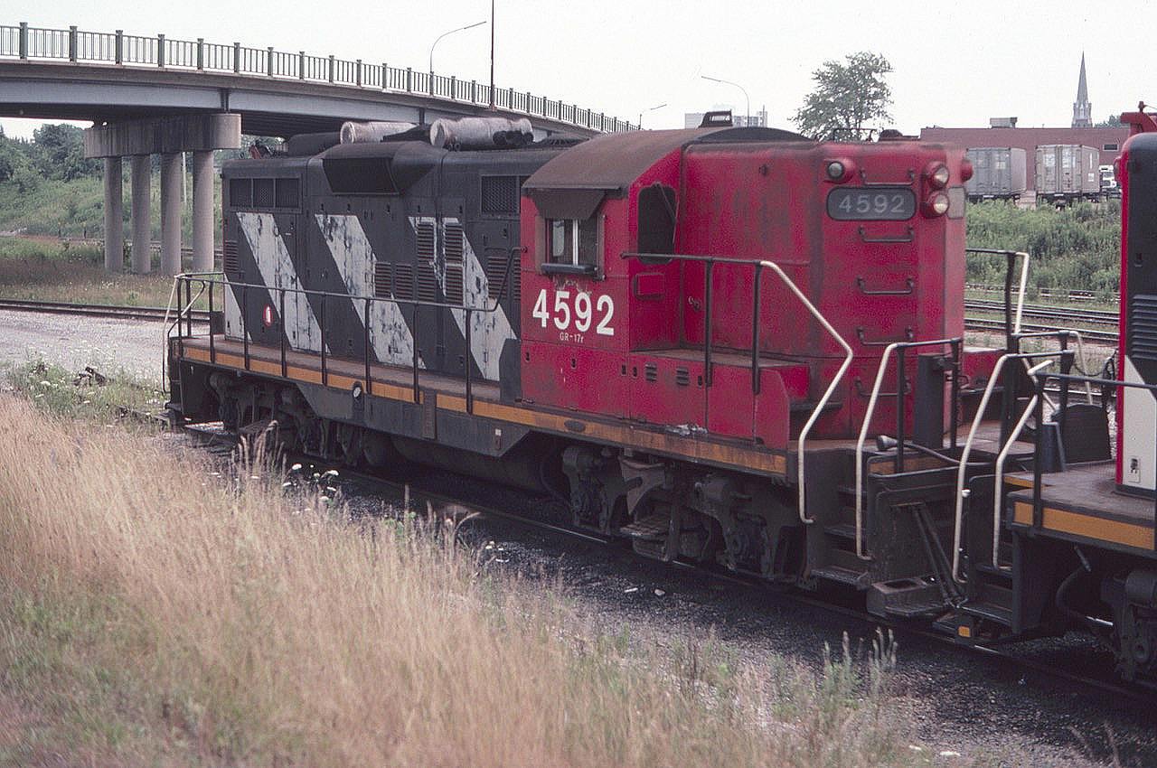 CN hi-nose Geep 4592 is seen at the former CN Niagara Falls yard near the yard office in August of 1982. The Victoria Avenue overpass is in the background. I was very surprised to come back years later and find the yard gone. This reminds us all to get pictures while we can, because time marches on!