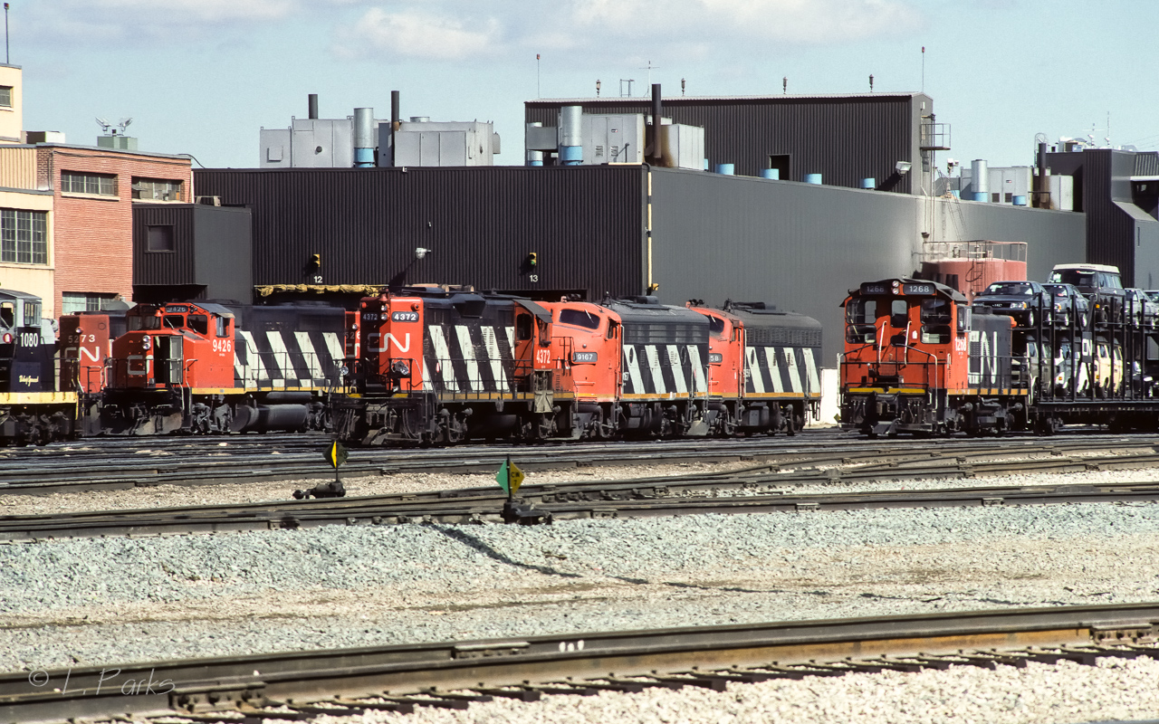 Sunday after lunch at the Calder diesel shop finds this varied display of GMD engines. The west tower job at the right was pulling a string of cars with a bi-level of VW's next to the 1268. Also of interest, I stopped in at the east tower before coming here. Parked in a stub track there were 4 superintendent cars, the 61202,61201,61200 and 70067.