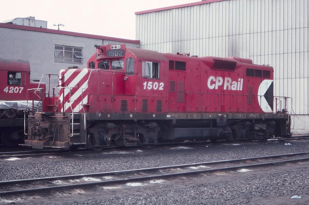 Dad drove into Agincourt Yard like he owned the place and read the Globe and Mail while I took photos. CP 1502, a GP7u, is seen at the engine terminal in August of 1983. Those were the days indeed.