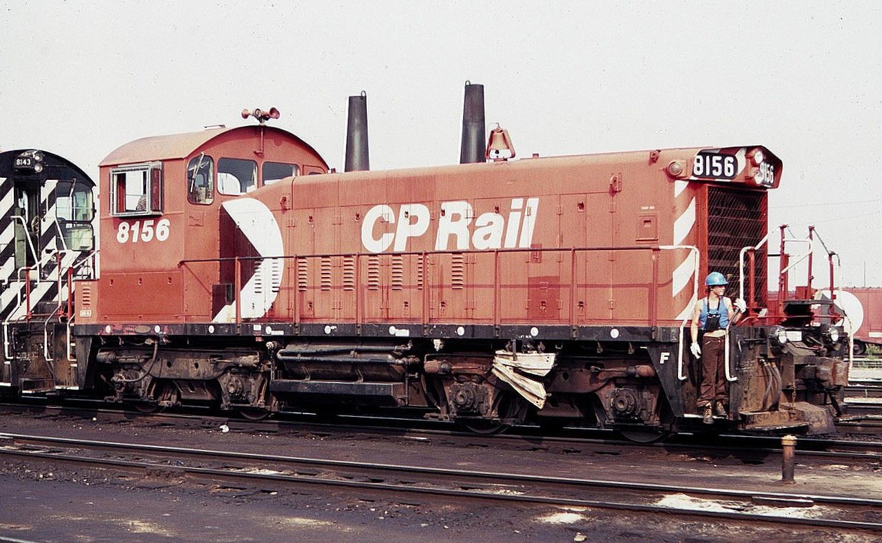 Once a common type of locomotive, end cab switchers are rarely seen nowadays. Shown here is SW1200rs CP 8156 at Agincourt yard in August of 1983, with an employee riding the front steps.