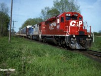 CP train 505 with SD40-2 5581, SOO Line SD40B 6450 and CR Leasing SD40 609 are approaching the east siding switch at Wolverton, which is situated just west of Ayr, Ontario on the Galt Subdivision. Here they would meet train 510, which had already taken the siding at Wolverton. This one of a kind SOO Line unit is ex-BN SD40B 7600 and nee-BN SD40 6302. While CRL SD40 609 is ex-Conrail 6262 and nee-PC 6262. 

