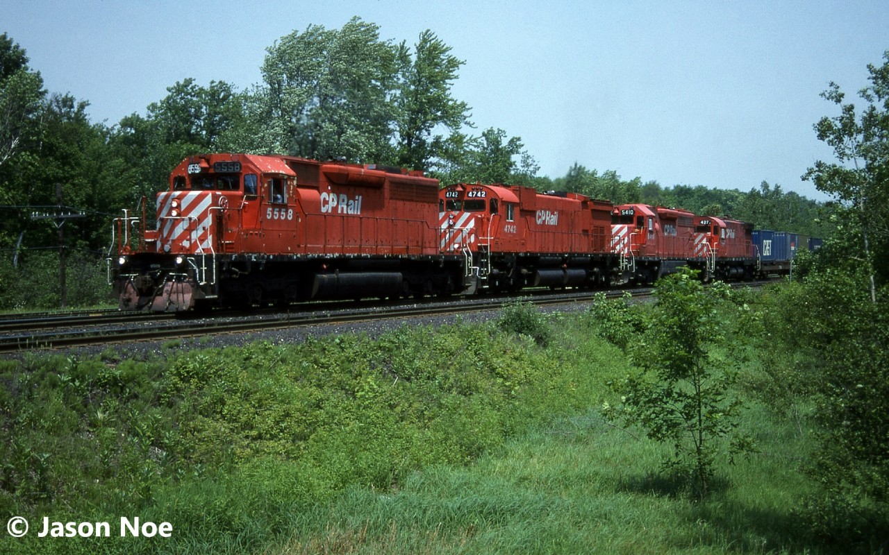 Following a meet with road railer train 528, CP 511 is seen approaching the First Line Nassagaweya crossing at the west-end of Guelph Junction on the Galt Subdivision. Train 511’s consist included SD40 5558, M-636 4742, SD40 5410 and C-424 4221. Big MLW 4742 was officially retired again on August 15. Also, it was among the last 4 M-636’s that remained operational through August 1995 prior to being shut down for good.