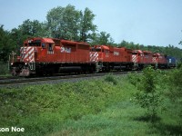 Following a meet with road railer train 528, CP 511 is seen approaching the First Line Nassagaweya crossing at the west-end of Guelph Junction on the Galt Subdivision. Train 511’s consist included SD40 5558, M-636 4742, SD40 5410 and C-424 4221. Big MLW 4742 was officially retired again on August 15. Also, it was among the last 4 M-636’s that remained operational through August 1995 prior to being shut down for good. 