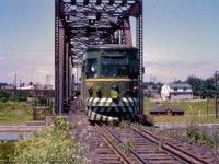 Making its way down the former mainline to Niagara Falls, car 623 of the Niagara St. Catharine's & Toronto Railway is seen eastbound crossing bridge 8 over the Welland Canal on an excursion.  By 1948, this section of track became freight only to serve Walker's Quarry, about 1.5 miles north of this spot on the east side of the canal, though NS&T excursions were known to explore all the industrial spurs with the visiting railfans.  Built in 1930 by the Ottawa Car Company, 623 was the last of four cars built for the Windsor, Essex & Lake Shore Rapid Railway.  These were sold to the Montreal & Southern Counties Railway during the mid-1930s.  Of the four cars, 620, 622, and 623 would be transferred to the NS&T during the summer of 1955.  All three cars would be scrapped in 1959.  <br><br>NS&T's mainline from St. Catharines - Niagara Falls began service in July 1900 via Merritton and Thorold, seeing passenger and freight movements.  Interchange was available with the CNR at both these intermediate locations, and with both the CNR and Wabash at Stamford on the CNR Welland Sub (today's Stamford Sub.)  Passenger service was first cancelled in June 1941, but revived during April the following year due to wartime measures.  The permanent end came during September 1947, with freight service wrapping up by the end of the year.  Rails would be lifted from Shriner's siding, just west of the canal, to Niagara Falls during the spring of 1948.  <br><br>Canal bridge 8, built in 1915, but without ships passing through until 1930, would see its last electric movements in July 1960, and last rail movement in 1964.  At this time, two sidings were built for Walker's quarry off the south side of the Grimsby Sub, just west of the Taylor Road overpass.  Both sidings followed along the 1870s Grand Trunk Railway alignment, which curved south, passing beneath the third Welland Canal <a href=https://www.railpictures.ca/?attachment_id=19247>via a tunnel.</a>  In the distance at left, boxcars can be seen on the NS&T-CNR interchange tracks, later becoming part of <a href=https://www.railpictures.ca/?attachment_id=56602>CN's Fonthill Spur, (1)</a> used <a href=https://www.railpictures.ca/?attachment_id=53279>in recent years by GIO (2)</a> and Trillium for car storage and access to Thorold customers.  CN's connection to this interchange was via the Thorold Sub, running from Merritton to Port Robinson.  <br><br>Off to the right and below the NS&T tracks sits CN's Thorold station, built circa 1930 with the construction of the fourth Welland Canal.  Built as the Welland Railway from Port Colborne - Thorold circa 1859, and coming under Grand Trunk ownership during the early 1880s, the line <a href=https://www.railpictures.ca/?attachment_id=7959>ran parallel to the canal</a> for most of its route, climbing the Niagara Escarpment initially as competition for the canal's traffic.  In the CNR era, this was the mainline for Fort Erie-bound trains, with Merritton - Thorold being helper territory.  Consolidations and Mikados, double and triple heading with Northerns, lifting freights upgrade, cutting off near the Thorold station.  Fort Erie racetrack trains from Toronto were also frequent visitors to this territory.  CN's Thorold station, <a href=https://www.railpictures.ca/?attachment_id=38497>shot by Arnold in 1976,</a> would burn down during the late 1970s.  <br><br>After the removal of <a href=https://www.railpictures.ca/?attachment_id=8018>canal bridge 10</a> in the late 1990s, what remained of the Thorold Sub was <a href=https://www.railpictures.ca/?attachment_id=15795>turned over to the Trillium Railway</a> along with much of the Niagara industrial lines, which are <a href=https://www.railpictures.ca/?attachment_id=50862>presently in the hands of GIO Rail.</a>  As of this writing, GIO stopped service over the Thorold Sub as of March 1, 2024, but the rails remain in place.  <br><br>Aerial maps of the Niagara region can be viewed for each decade from the 1920s through the 1970s by <a href=https://experience.arcgis.com/experience/d6985c1b40ca4604bcb7f9716f15a285/page/Page-1/#data_s=id%3AdataSource_add_from_url_entry-17f0948d13c-layer-51-AirIndex1971_2021_5644%3A35>clicking here.</a>  Note various stages of canal construction (4th canal during the 1920s, and the Welland bypass project in the 1970s,) as well as railway relocations through the years.  The book, <i>Niagara, St. Catharines & Toronto Railway</i> by John M. Mills is also an excellent resource.  <br><br>More Bridge 10: <br><a href=https://www.railpictures.ca/?attachment_id=14254>Mooney; 1997</a> <br><a href=https://www.railpictures.ca/?attachment_id=36274>Mooney; 1997</a>  <br><br>More Lock 7:<br><a href=https://www.railpictures.ca/?attachment_id=51121>Brown; 1997</a> <br><a href=https://www.railpictures.ca/?attachment_id=54709>Brown; 1998</a> <br><a href=https://www.railpictures.ca/?attachment_id=10817>Elliott; 2001</a> <br><a href=https://www.railpictures.ca/?attachment_id=46547>Host; 2021</a>  <br><br><i>Original Photographer Unknown, Al Chione Duplicate, Jacob Patterson Collection Slide.</i>