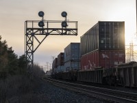 Headed into the late evening sun, CN Z149 rolls westward under 1960's-era searchlights at McCowans on the York Subdivision.