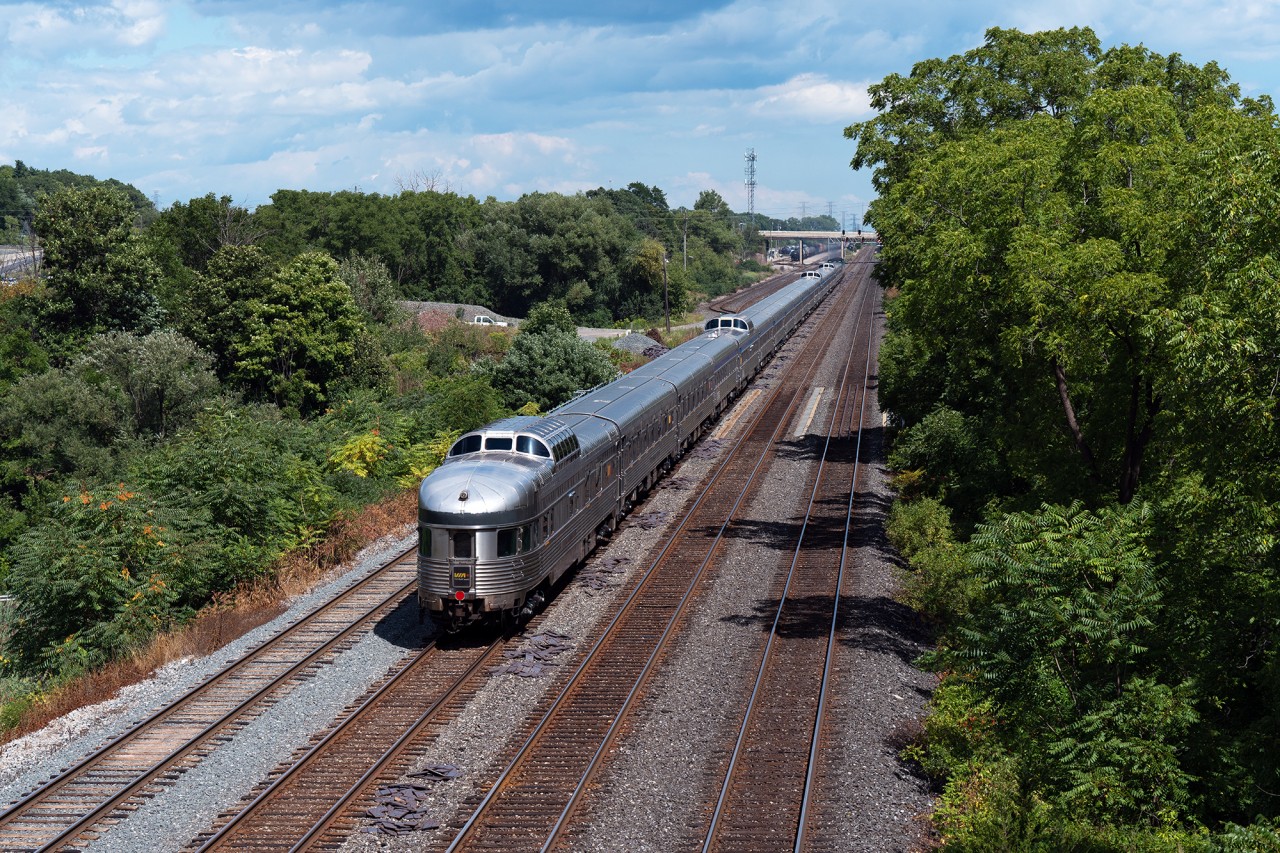RARE TO SEE: On the morning of August 24th, 2025, CN double stacker Q107 derailed at Doncaster, taking multiple tracks out of service on both the Bala and York Subdivisions, conveniently right before VIA no.1, the Canadian, was set to depart Toronto's Union Station on schedule at 0955 hrs. The Q107 derailed on the northwest quadrant of the Doncaster diamond, which is the same connector that VIA needs to be able to reach the Bala after using the MX Newmarket and York Subdivisions on their way out of the city. 

As luck would have it, Snider Sunday was in effect at Snider West when we got word of no.1 using the Oakville Sub...beyond Mimico Toronto Maintenance Centre. This gave us the notion the train A) was not cancelled and still very much in service, and B) was likely utilizing the entire Oakville Sub to reach Bayview Jct, the idea being no.1's crew would wye at Bayview and travel all the way back east, bypassing Union station, and climbing up the Don Valley to get back on track for their trip, albeit four hours later than originally intended.

VIA 88709, the observation dome park car 'Laurentide Park' brings up the tail end of the Canadian, seen here cruising eastbound under Lemonville Rd, approaching Aldershot on a bright and sunny afternoon.