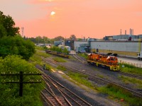 The morning sun rises over GM Oshawa, where G&W's Railsynergy job has just finished spotting frame loads inside the plant.  Shortly, they will spot the empties back in the CN yard, before running down the General Motors Lead to lift loaded racks.