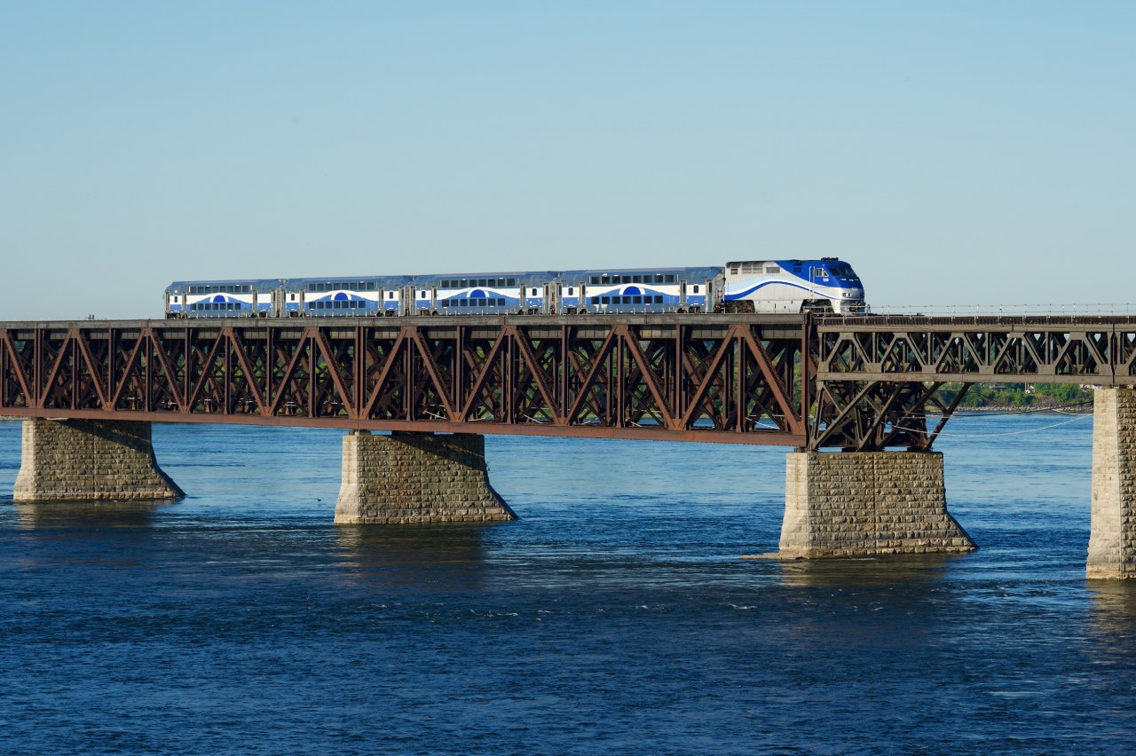 EXO 1328 leads EXO 76 from Candiac as it crosses the St. Lawrence River and approaches the next stop at LaSalle Station.