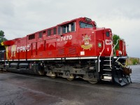 Fresh CP 7470 leads CPKC 112 over a crossing as it approaches Lachine IMS Yard on a rainy morning. CP 7470 features a logo honouring the Lord Strathcona's Horse (Royal Canadians) armoured regiment.