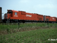 Amid an early summer heat wave, the Southern Ontario air sat heavy and muggy. In retrospect it was the beginning of a long dry season that would see many weeks with the same weather pattern. However, when you’re young these things tend to bother you less. Such was the case here as Andy Gertz and I headed towards London following the Galt Subdivision, in his compact orange Toyota. Once near the village of Ayr, his scanner crackled to life with the RTC calling 5527 east. The approaching eastbound was given a clearance to take the siding at nearby Wolverton for a meet with westbound intermodal 503. Being very close already, we diverted our route towards the east switch Wolverton to await both trains. At the time, Trussler Road was a much less busy thoroughfare and Wolverton was only a long siding in the middle of two farm fields, as the current Wolverton Yard was more than a decade away from being constructed. Soon 5527’s headlight came into view at the top of the siding’s crest, and the train slowly made its way towards us. In true mid-90’s fashion we had no idea what the power was, however with CP’s ever growing lease fleet odds were good it was going to be colourful. As 5527 neared we heard the unmistakable bark of not one but two M-636’s trailing, CP 4742 and 4743, behind the lead SD40 and HLCX 5008. 
<br>
In the final summer of their existence on CP, anytime you would see a big MLW could be your last, as by June 1995 only about 8 remained in service. And with CP’s new order of GE AC4400CW’s due to arrive in late summer the clock was ticking. So, on that muggy afternoon, Andy and I took many frames on Kodachrome of the two M-636’s as they waited the arrival of 503. Despite their impending retirements, both units still looked sharp in their matching action red paint, unlike many of the already fallen and retired M-636’s in the same class. With 503’s horn approaching from the east, we walked back to the crossing hoping 4742 and 4743 would put on a good show departing the siding following the meet….

