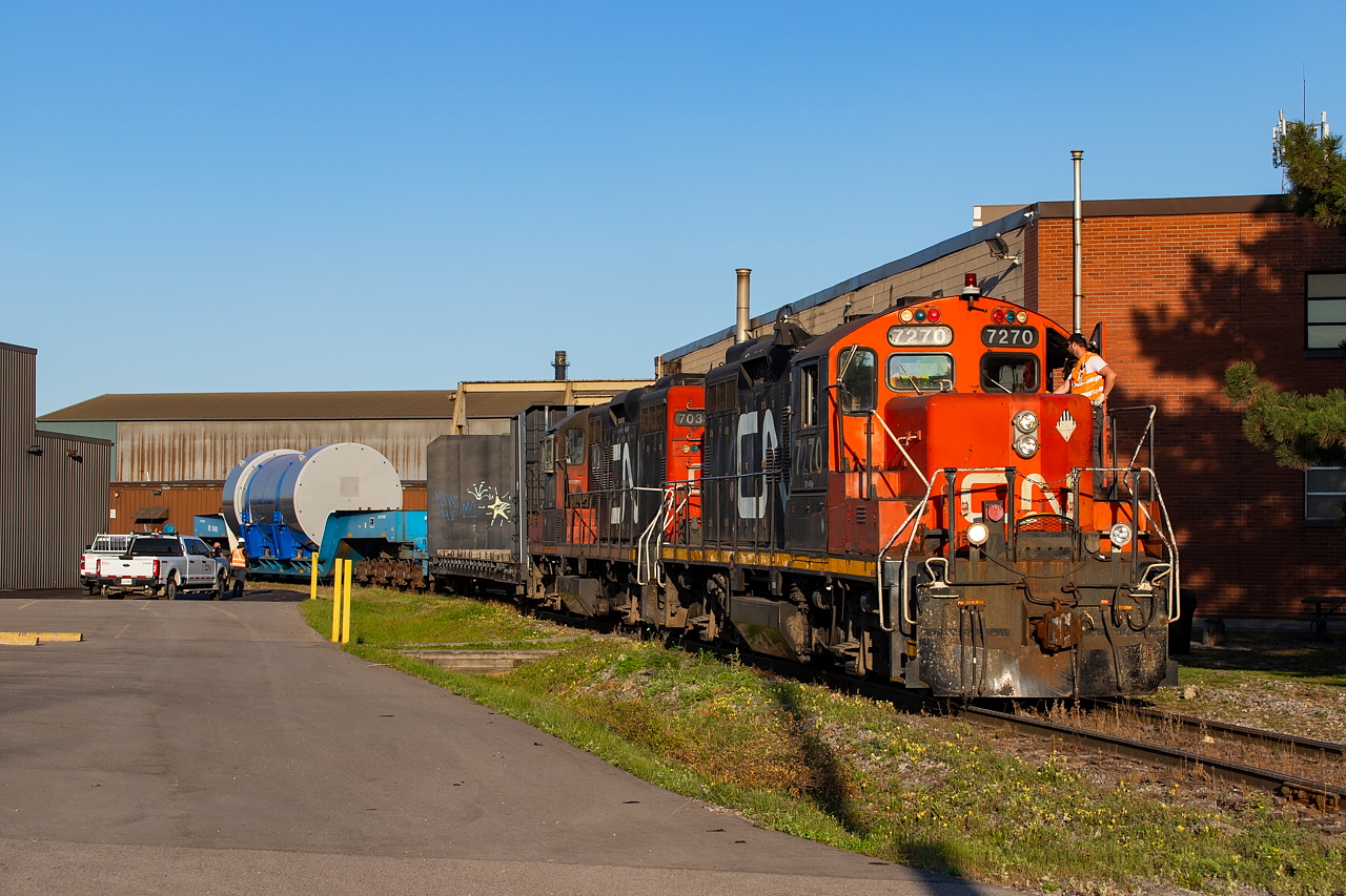 Went out this night for the first time in a while. It was a nice night, and the days are getting ever shorter, so I figured what the heck. Soon after, I hear 581 talking to the 1600 about needing to get in the clear, which certainly piqued my interest. Immediately, I wondered if they were at Hooper, a place known for some interesting loads (example here
 and here). Sure enough, they soon appeared out of the Eastport area with a D9 dimensional and a convoy of trucks following them - including CN and even a PR firm documenting the move. I'd soon come to learn this was a test move, with the goal to get it out on the Grimsby and up to 35mph before taking it back down the N&NW and back to Hooper. I am under the impression the test was to see how the load itself responded to being moved. Sounds like they have shipped it other ways, and are also building another model with different materials to see how it responds (including to drop tests). The load itself is from Westinghouse - and I have no idea what it is but am suspecting it may be a mini reactor of sorts. Curious if anyone knows. Chased it but this was the only photo I got. The shadows far too long at the time of day for any other location to work. Was fun nonetheless and got to learn a lot from the people who were being paid to follow it.