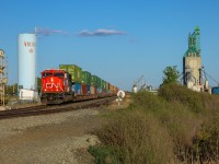 CN Q 11991 13 highballs through Viking with recently rebuilt CN 8326. 