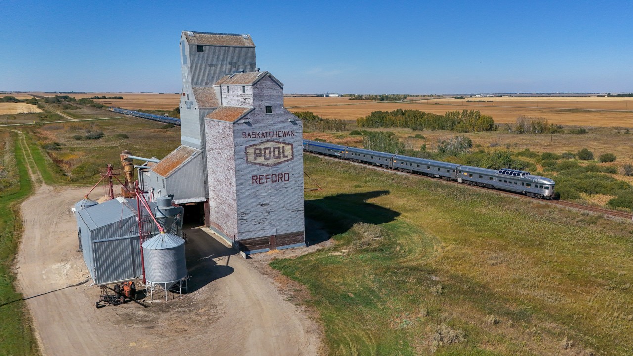 The westbound Canadian, is running right on schedule as they cruise past the elevator at Redord.  While it is no longer served by rail, and flanked by two super elevators, the structure is still used by local farmers for storing grain.