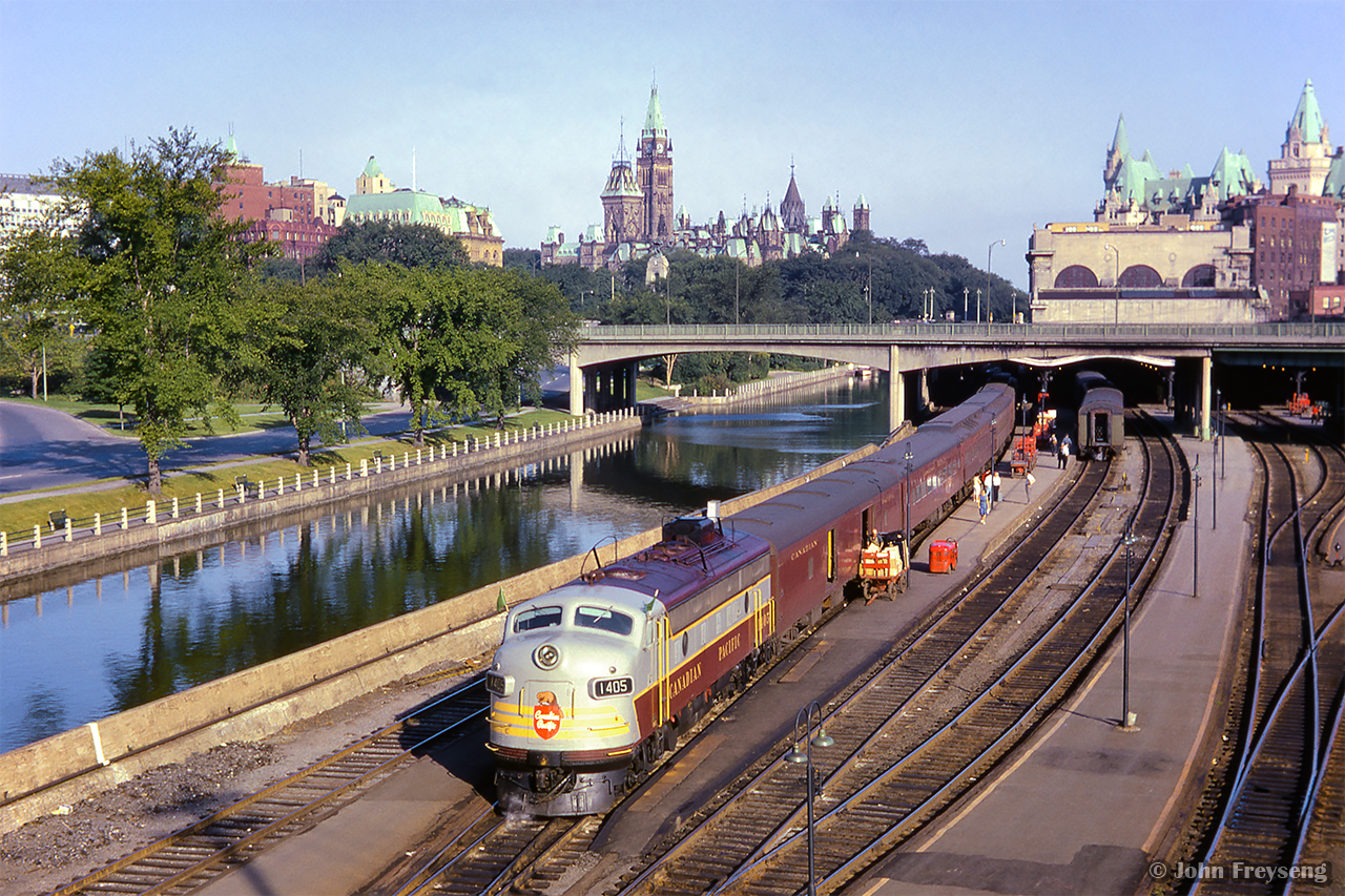 The Parliament Buildings loom over the early morning scene at Ottawa Union Station, as the first section of the "Dominion" pauses before departing for Montreal.  Shortly before this scene, the train was photographed having just crossed the Alexandra bridge.

Scan and editing by Jacob Patterson.