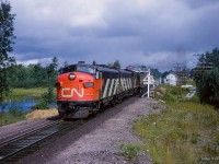 Departing Washago, train 52, the <i>Super Continental,</i> is southbound over the Severn River.  Note the drawbridge warning sign, old water tower.

<br><br><i>Scan and editing by Jacob Patterson.</i>