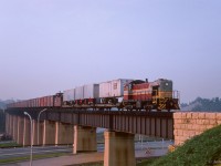 A CPR transfer from Agincourt Yard to freight sheds and piggy back ramps at John Street trundles over the "half mile bridge" in Toronto's Don Valley behind one of CPR's ALCO S-2 switchers.  About halfway through its career, the 1944 unit would last until retirement and scrapping in 1982.

<br><br><i>Scan and editing by Jacob Patterson.</i>