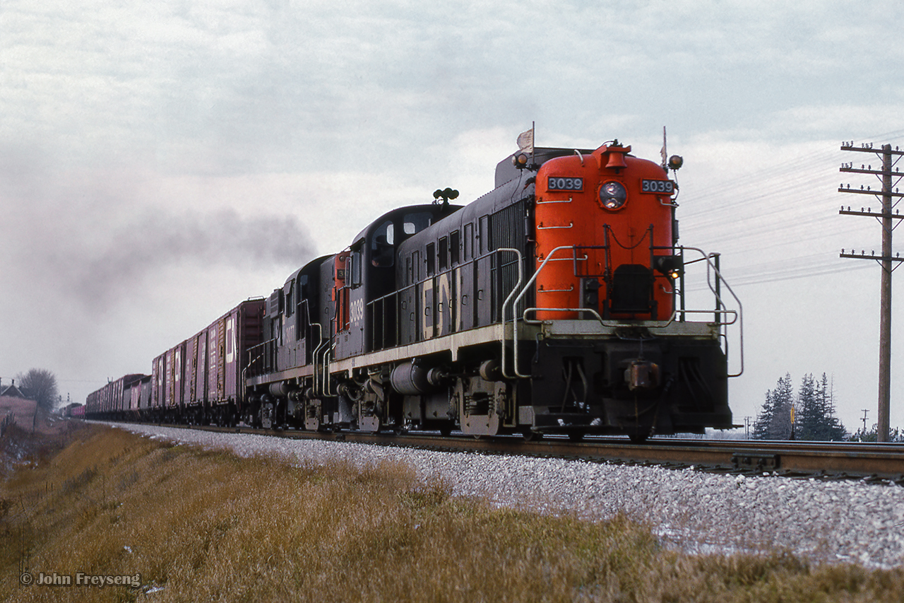 Just east of CN's Pickering station, a pair of MLW units (rs3/rs10) fly eastbound on the point of an extra freight.

Scan and editing by Jacob Patterson.