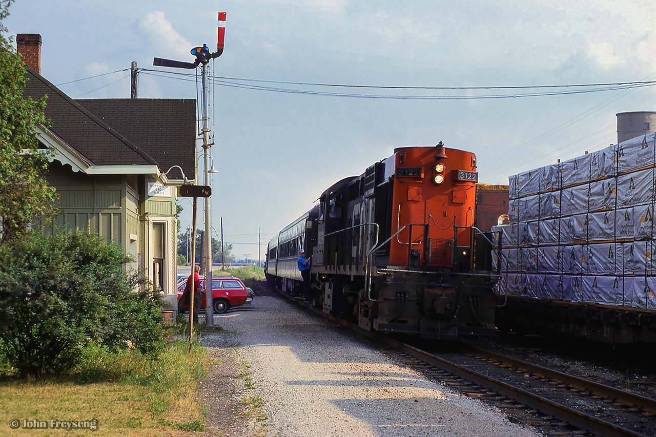 Commuter train 169, the Barrie Bullet, arrives at Maple, where a crew member is ready to step down for orders during their station stop.Scan and editing by Jacob Patterson.