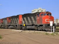 Departing the east end of CN's Bissel Yard, a set of GMD GP40-2LWs pass the large cement plant, presently owned by Heidelberg Materials.<br><br><i>John Freyseng Photo, Jacob Patterson Collection Slide.</i>