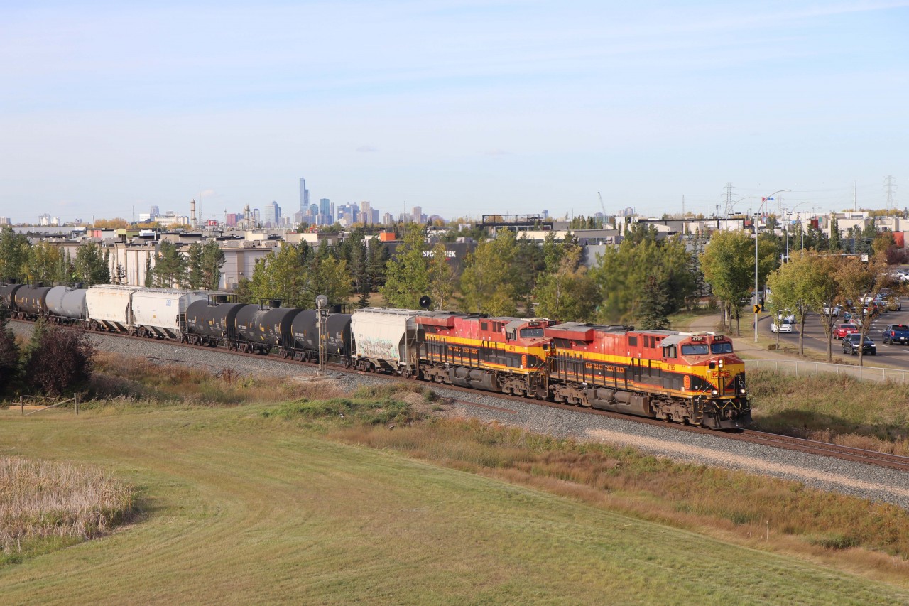 Having just departed Edmonton's Lambton Park yard, CPKC 419 begins its trip to the Union Pacific interchange at Eastport, Idaho behind KCS power--ES44ACs 4795 and 4799, with KCSM AC4400CW 4504 as tail end DPU. Downtown Edmonton is in the distance.