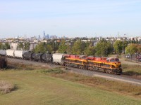 Having just departed Edmonton's Lambton Park yard, CPKC 419 begins its trip to the Union Pacific interchange at Eastport, Idaho behind KCS power--ES44ACs 4795 and 4799, with KCSM AC4400CW 4504 as tail end DPU. Downtown Edmonton is in the distance.