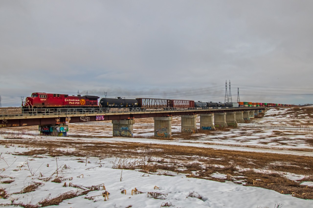 As the winter was slowly fading away in Southern Manitoba. CP 8004 leads the way into Winnipeg over a frozen floodway.
