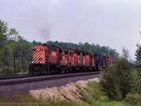 A summer afternoon at Guelph Junction finds one of the slag trains <a href=https://www.railpictures.ca/?attachment_id=56067>mentioned in the comments here by Ron Bowman,</a> dropping slag on the Galt Sub.  A pair of GMD GP35s trail the RS10 with a spreader up first behind the power.

<br><br>@Ron Bowman, any stories regarding these trains, working them or otherwise?

<br><br><i>Bill McArthur Photo, Jacob Patterson Collection Slide.</i>