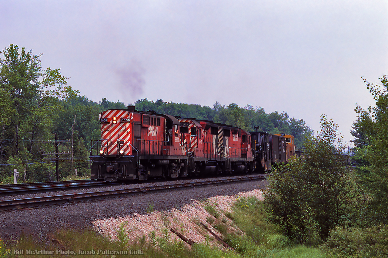 A summer afternoon at Guelph Junction finds one of the slag trains mentioned in the comments here by Ron Bowman, dropping slag on the Galt Sub.  A pair of GMD GP35s trail the RS10 with a spreader up first behind the power.

@Ron Bowman, any stories regarding these trains, working them or otherwise?

Bill McArthur Photo, Jacob Patterson Collection Slide.