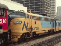 The Northlander passenger train with ONT 1984 on the head end is being brought down to the west end of Toronto Union Station from the coach yards by CN switcher 8516 on this hot summer day in August of 1985. Even way back then there was always a lot of construction activity in Toronto, as seen above the 1984.