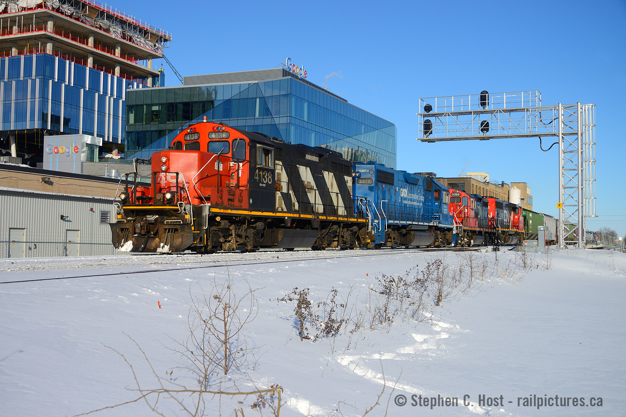 CN 568 is passing Google's Canadian HQ with a 1950's built GP9 in the lead on a beautiful winter's day. Talk about a contrast in technologies.