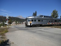 <b> Westbound VIA No. 2 ... Is that possible </b> <br>
VIA 002 The Canadian with VIA 88708 Jasper Park leading is heading west out of the station track in Jasper on this beautiful September morning. <br>
With major track realignment and other construction work at the east end of CN's Jasper yard, it was necessary for VIA No. 2 to complete its normal station stop and servicing, then make a reverse move from the station track and head west to CN Home at Mile 0.5 on the Albreda Sub. before resuming its eastward journey to Edmonton, Winnipeg, and Toronto. <br>
Under the watchful eye of the second engineer, the movement rolls across Hazel Avenue crossing at the west end of CN's Jasper yard.