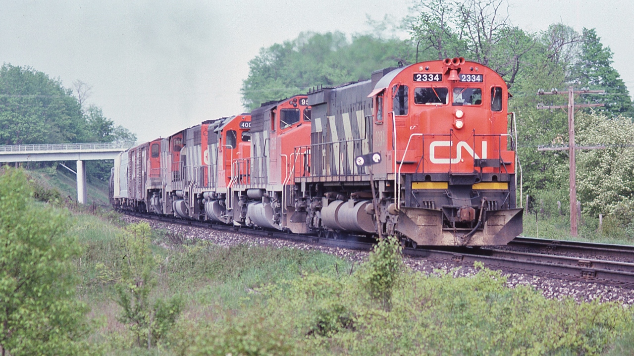 Seventies Super Power!


On the Kingston Sub-Division


Five units, four models, two builders. 


MLW M-636, GP40-2LW, GP40 (renumbered into the 9300 series in 1981), GP40-2LW and MLW M-420


Westbound under the Wesleyville bridge, May 26, 1979 Kodachrome by S.Danko.


And a thank you to Nikon for producing the 135mm f2.8 lens!