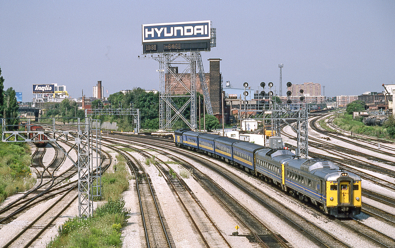 It is the 1980's in Toronto where two VIA trains have been combined after servicing most likely to run to Toronto Union Station where the two trains would be split. On this end is VIA 6217.