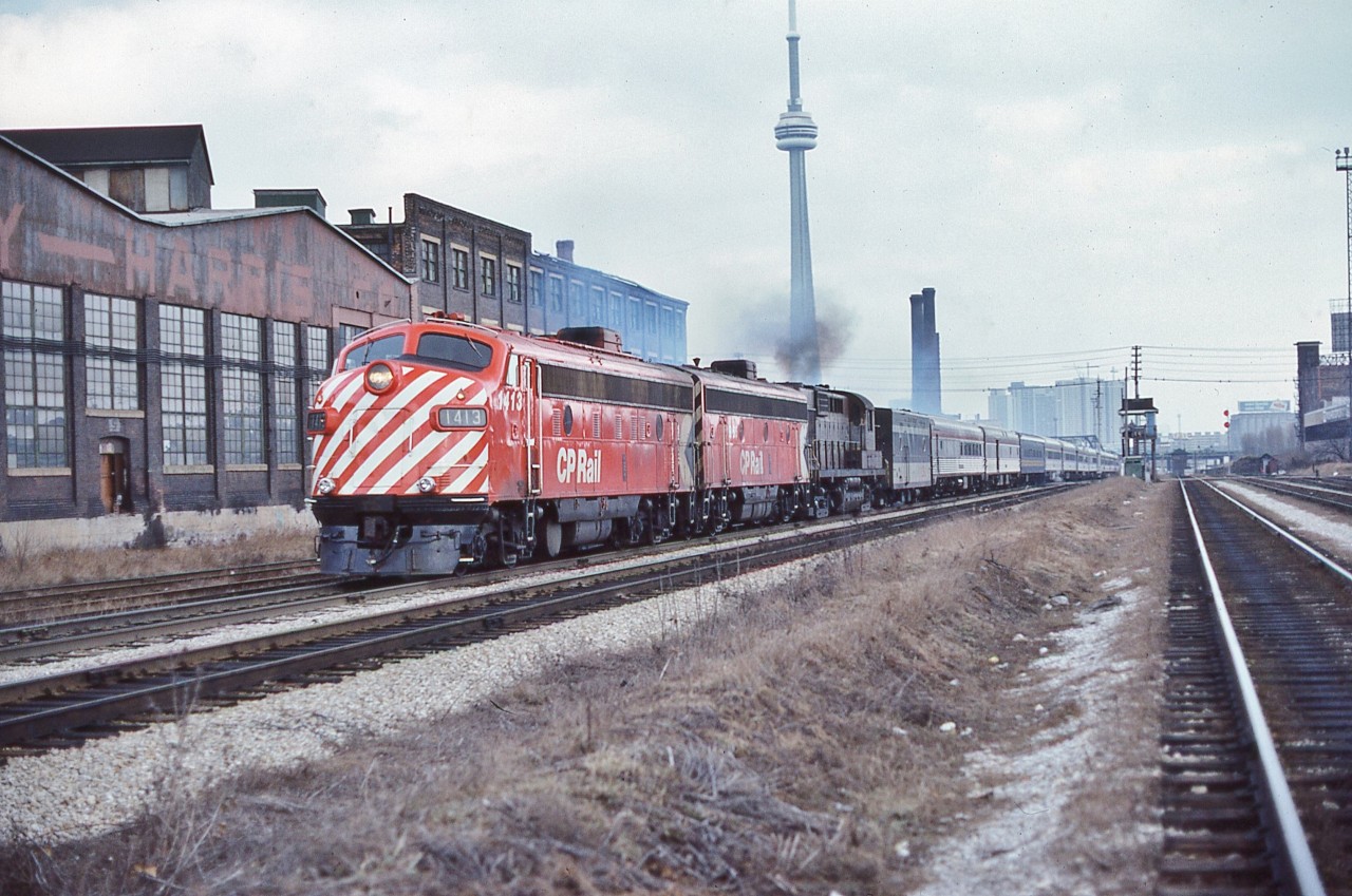 Times a changing – note the derelict Massey Harris plant building....


The 'new'  daily VIA #1  Canadian is on the CN Weston Sub., heading to the CN Newmarket Sub., - passing the occupied Strachan Ave. Crossing Tower. 


At CN Boyne (Bala Sub) #1 will enter CP Rail   at Reynolds (Parry Sound Sub)  to CP Rail Sudbury (no interchange of cars) and continue on CP Rail to the CP Rail Vancouver Station. 


And interesting times, VIA#1 power: ex CP Rail  FP9A #1413; ex CP Rail  F9B #1954; leased CP Rail  RS-10s #8576 in Script livery.


The view from the CP Rail Galt Sub (where CP Rail  #11 & #12  The Canadian operated daily for 23 years), March 10, 1979 Kodachrome by S.Danko.


Interesting: At that time the operation of the ditch lights was at crew discretion.


note the ex CP Rail Dining Room car dead-heading behind  the leased CN Steam Generator car.


At this time  the daily VIA #3 Super Continental operated from Central Station, Montreal on CN to Dorval  then on to CP  Rail to CN North Bay where an across platform connection was made for westbound Toronto originating passengers arriving on daily #121 – yes the ONR The Northlander provided the western service for CN lines passengers. And daily eastbound #4 passengers to Toronto walked across the CN North Bay platform to daily  #122 The Northlander. 


The transcon  arrangements described lasted one season, by June 1979 the trains were swapped: Canadian daily #1 & #2 served Montreal only; the Super Continental daily #3 & #4 served Toronto only and the westbound trains were combined at CP Rail  Sudbury continuing on CP Rail  to Thunder Bay – Kenora to CN Winnipeg then split onto the separate CN and CP Rail routes to CN Vancouver (and eastbound vice versa).[ And for one summer season only 1979 CP Rail hosted four daily transcontinentals #1, #2, #3 & #4,  CP Rail Sudbury –  Thunder Bay – Kenora to CN Winnipeg:  where cars were interchanged ]


And by June 1979  a 'new' VIA #7 & #8  (daily except Tuesdays) served the CN route Capreol – Winnipeg.


Got it?


Whew!
