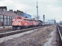 <br>
<br>
Times a changing – note the derelict Massey Harris plant building....
<br>
<br>
The 'new'  daily VIA #1  Canadian is on the CN Weston Sub., heading to the CN Newmarket Sub., - passing the occupied Strachan Ave. Crossing Tower. 
<br>
<br>
At CN Boyne (Bala Sub) #1 will enter CP Rail   at Reynolds (Parry Sound Sub)  to CP Rail Sudbury (no interchange of cars) and continue on CP Rail to the CP Rail Vancouver Station. 
<br>
<br>
And interesting times, VIA#1 power: ex CP Rail  FP9A #1413; ex CP Rail  F9B #1954; leased CP Rail  RS-10s #8576 in Script livery.
<br>
<br>
The view from the CP Rail Galt Sub (where CP Rail  #11 & #12  The Canadian operated daily for 23 years), March 10, 1979 Kodachrome by S.Danko.
<br>
<br>
Interesting: At that time the operation of the ditch lights was at crew discretion.
<br>
<br>
note the ex CP Rail Dining Room car dead-heading behind  the leased CN Steam Generator car.
<br>
<br>
At this time  the daily VIA #3 Super Continental operated from Central Station, Montreal on CN to Dorval  then on to CP  Rail to CN North Bay where an across platform connection was made for westbound Toronto originating passengers arriving on daily #121 – yes the ONR The Northlander provided the western service for CN lines passengers. And daily eastbound #4 passengers to Toronto walked across the CN North Bay platform to daily  #122 The Northlander. 
<br>
<br>
The transcon  arrangements described lasted one season, by June 1979 the trains were swapped: Canadian daily #1 & #2 served Montreal only; the Super Continental daily #3 & #4 served Toronto only and the westbound trains were combined at CP Rail  Sudbury continuing on CP Rail  to Thunder Bay – Kenora to CN Winnipeg then split onto the separate CN and CP Rail routes to CN Vancouver (and eastbound vice versa).[ And for one summer season only 1979 CP Rail hosted four daily transcontinentals #1, #2, #3 & #4,  CP Rail Sudbury –  Thunder Bay – Kenora to CN Winnipeg:  where cars were interchanged ]
<br>
<br>
And by June 1979  a 'new' VIA #7 & #8  (daily except Tuesdays) served the CN route Capreol – Winnipeg.
<br>
<br>
Got it?
<br>
<br>
Whew!