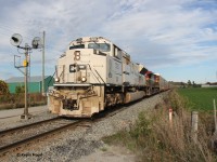 Military tribute unit CP 7021 and KCSM 4572 power CPKC 137 towards Wolverton for its usual work. It's pictured about to cross Dumfries Rd. between Cambridge and Ayr with an older style searchlight signal still online.