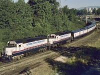 For their first few seasons, Rocky Mountaineer utilized ex ATSF GE B36-7 units, but in 1996, leased HELM GP40-3 power took over.  Here are HATX 804 and 805 eastward from Vancouver (timetable southward) on BNSF between signal gantries at Braid in New Westminster, and directly alongside the switch that provides the CP Jct. connection from CP’s Westminster sub., as seen on Thursday 1996-08-01 at 0851 PDT from the Brunette Avenue overpass.