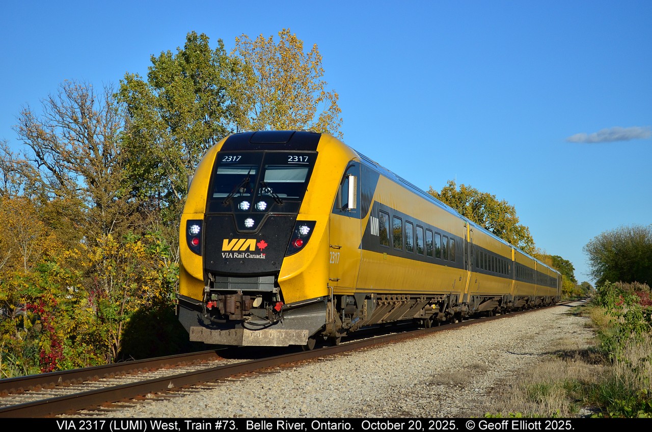 October 20th VIA Train #73 was running almost 2 hours late on it's trip from Toronto to Windsor.  I had heard that the "Lumi" set was on it and I wanted to try to get it with a bit of Fall color, but b/c it was running so late I was already home.  When I saw that it had left Chatham I headed over to the VIA tracks in Belle River and, after waiting for what seems like forever, got this shot of "Lumi" in behind Rona.  Turned out not too bad, but had really hoped for more color in the trees.  Oh well....  Next year.
