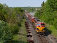 In this image, two KCS SD70MACe’s are on the head end of this Herzog GPS train, which is dumping ballast on the Galt Sub between Guelph Jct. and Orr’s Lake. After some confusion over the radio about work authorities and who had track time where, the WGA crew finally got the work authority they needed and the onboard Herzog crew began to work their magic in the area of expertise of ballast dumping and so the chase was on. I believe about ten to twelve foamers were on the Hwy 6 overpass waiting for this guy.