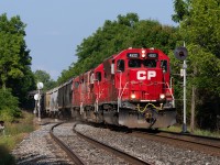 CP's Windsor Sub local bursts out of London with a three-pak of Geeps at full throttle, seen here knocking down the finial-adorned searchlight signals at the east end of Lobo siding.