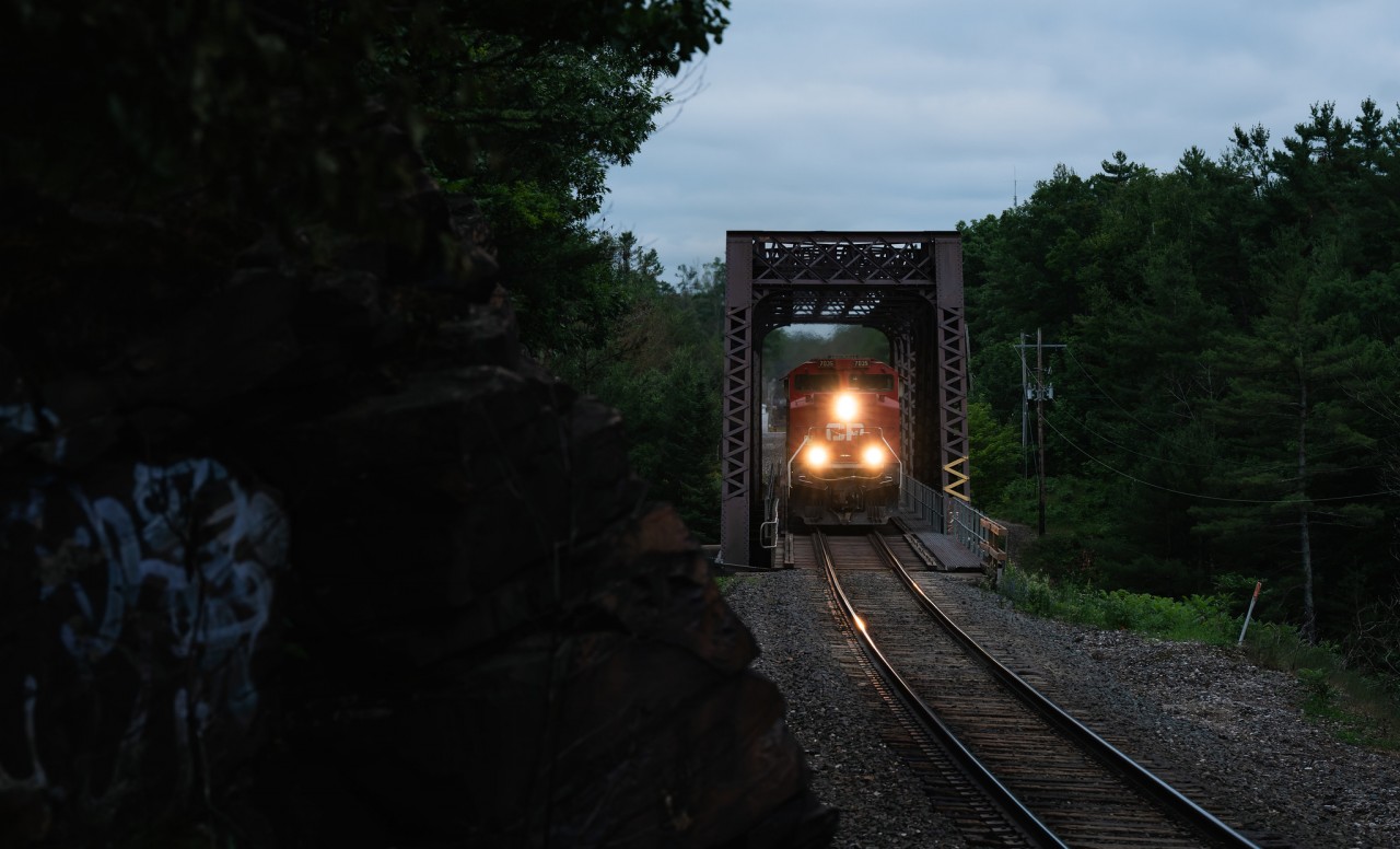Toronto to Winnipeg freight no.421 hustles through Severn Falls, Ontario, soaring over the Trent-Severn waterway on a truss bridge just north of Buckskin, at mile 104 of the CP Mactier Subdivision.

So many effin' mosquitos...
