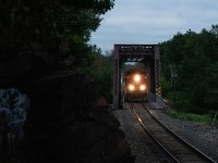 Toronto to Winnipeg freight no.421 hustles through Severn Falls, Ontario, soaring over the Trent-Severn waterway on a truss bridge just north of Buckskin, at mile 104 of the CP Mactier Subdivision.

So many effin' mosquitos...