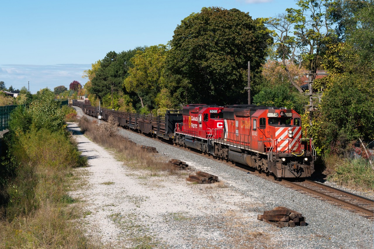 Two CP 40-2's make their way south down the Mactier Sub at John Street with a welded rail train for work on a Metrolinx project close to West Toronto...they will be dumping rail for future bridge widening and station construction over St Clair Ave on the Weston Sub.