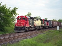 Westbound at Tansley on a pleasant June day...remanufactured CN SD40U locos 6003 and 6007 sandwich an NRE 807 for power as the train comes up to #1 Sideroad. My map indicates the north side of the road is Milton, the south side, Burlington. I've always referred to this area by the old name, Tansley. This was an enjoyable place to hang out back then, when everything was quiet but the railroad.
Image shot with Mamiya 645 film camera with 400 ISO Fuji Reala for those interested.