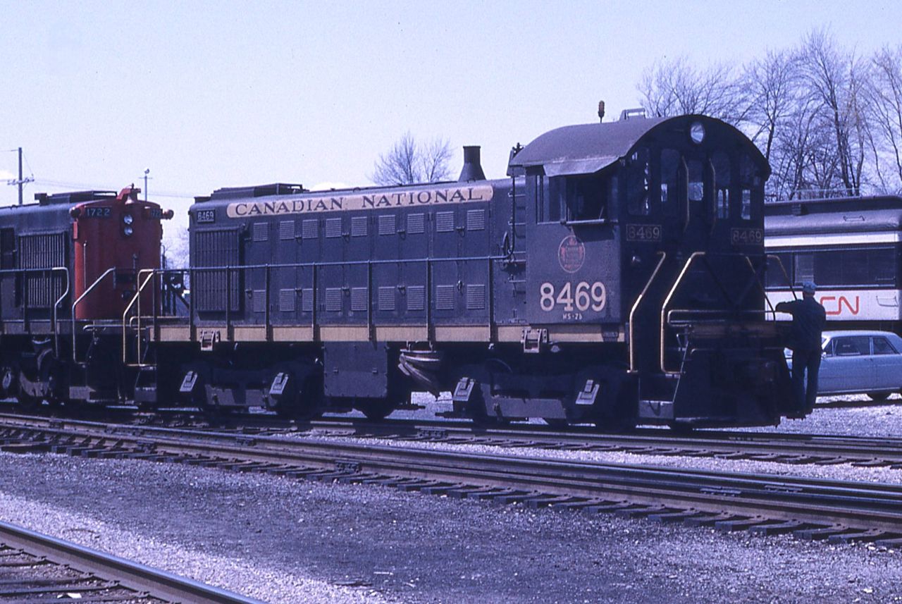CN MLW switcher 8469 is shown being shuffled around Stratford yard.  The 8469 was built by MLW in 1953.  It is classed as MS-7b and is equipped with 14EL brakes.