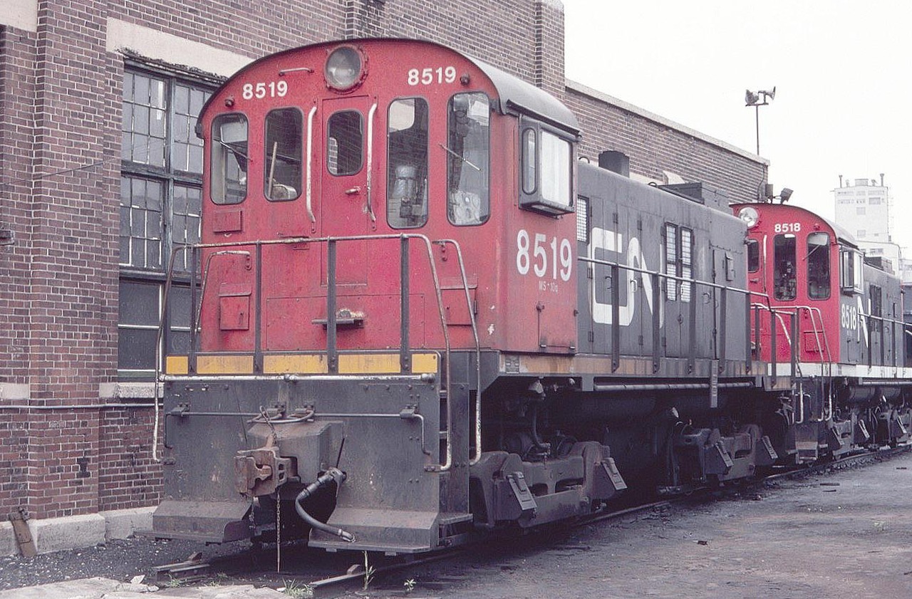 CN 8519 MLW S-13 coach yard switcher is seen taking a break behind the shops in July of 1982. These switchers were once ubiquitous at Toronto Union Station and Spadina Coach Yard, moving passenger car consists around.  Hard to believe you could wander around and take pictures like this back then. Note the journal lids for the old friction bearings.