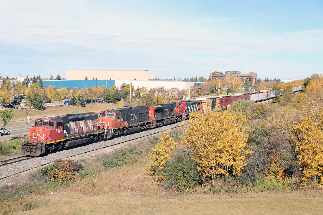 A41851 from McLennan rolls slowly through the outskirts of St. Albert behind SD40-2W 5295, SD75I 5670, C44-9W 2657, and SD40-2W 5321...Soon it will end its trip over the former NAR at Dunvegan Jct and continue to CN's Walker Yard. Fall colours are peaking in the Edmonton area, unfortunately a bit muted due to dry late summer weather.