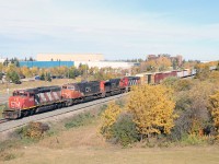 A41851 from McLennan rolls slowly through the outskirts of St. Albert behind SD40-2W 5295, SD75I 5670, C44-9W 2657, and SD40-2W 5321...Soon it will end its trip over the former NAR at Dunvegan Jct and continue to CN's Walker Yard. Fall colours are peaking in the Edmonton area, unfortunately a bit muted due to dry late summer weather.